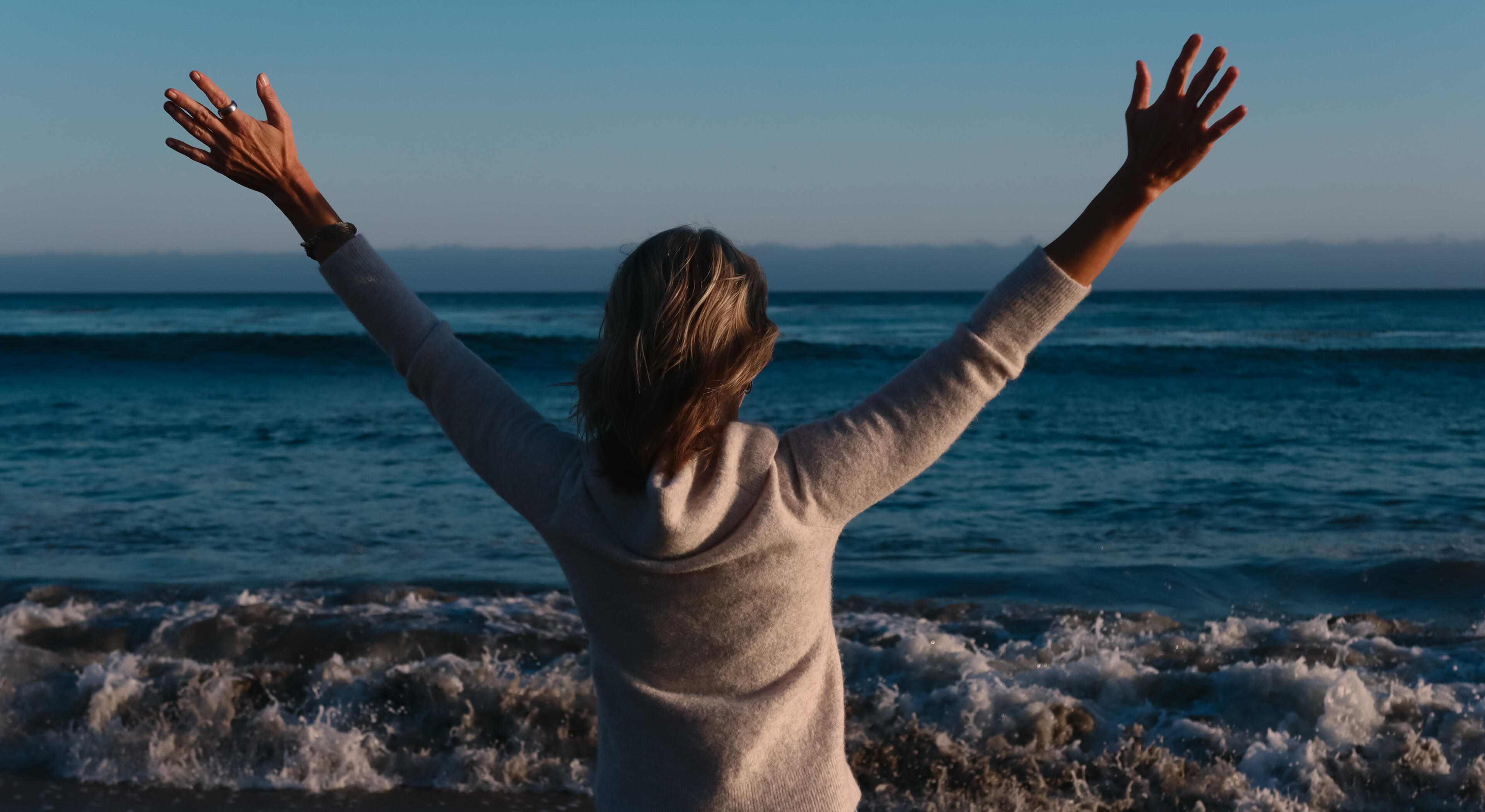 MIchelle (Mika) Waters, Founder of Waters Edge Co Close-up headshot of blonde-haired woman smiling for the camera. She is wearing a light colored denim jacket.